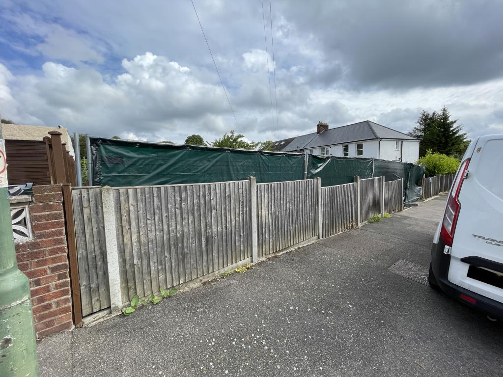 Lot: 117 - PLOT WITH PLANNING FOR TWO SEMI-DETACHED HOUSES - Outsdie view of front boundary site fence from Myrtle Road